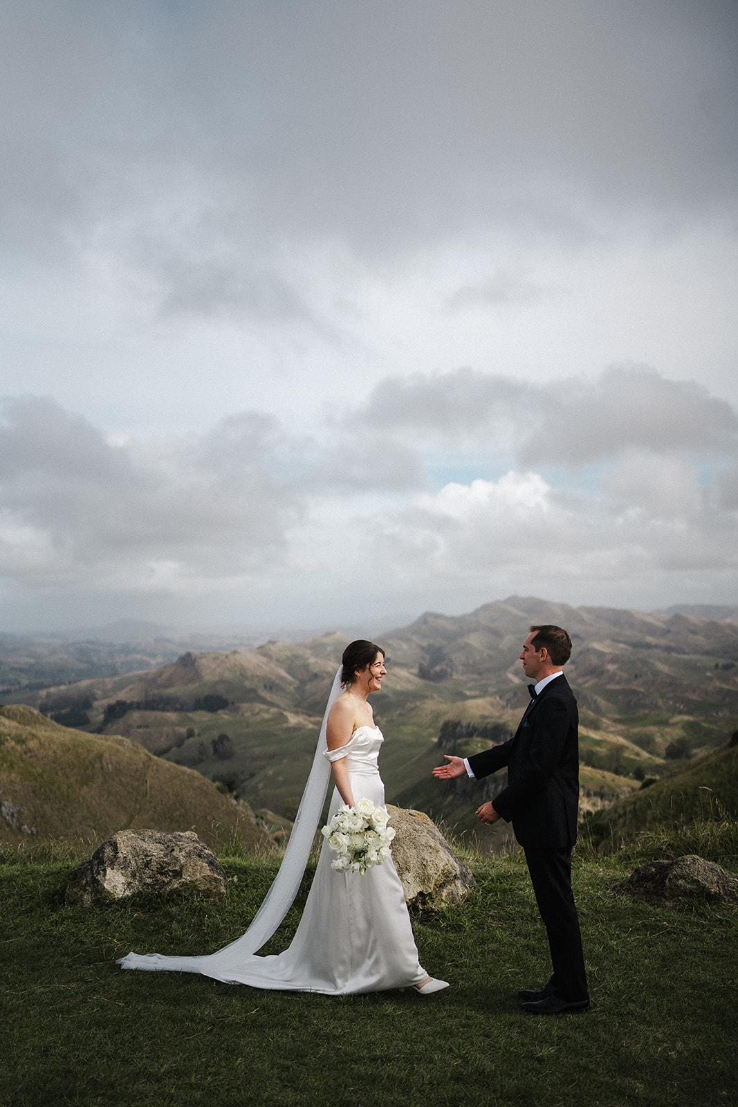 Bride and groom laughing together on Te Mata Peak in Hawke's Bay, New Zealand, photographed by Meredith Lord